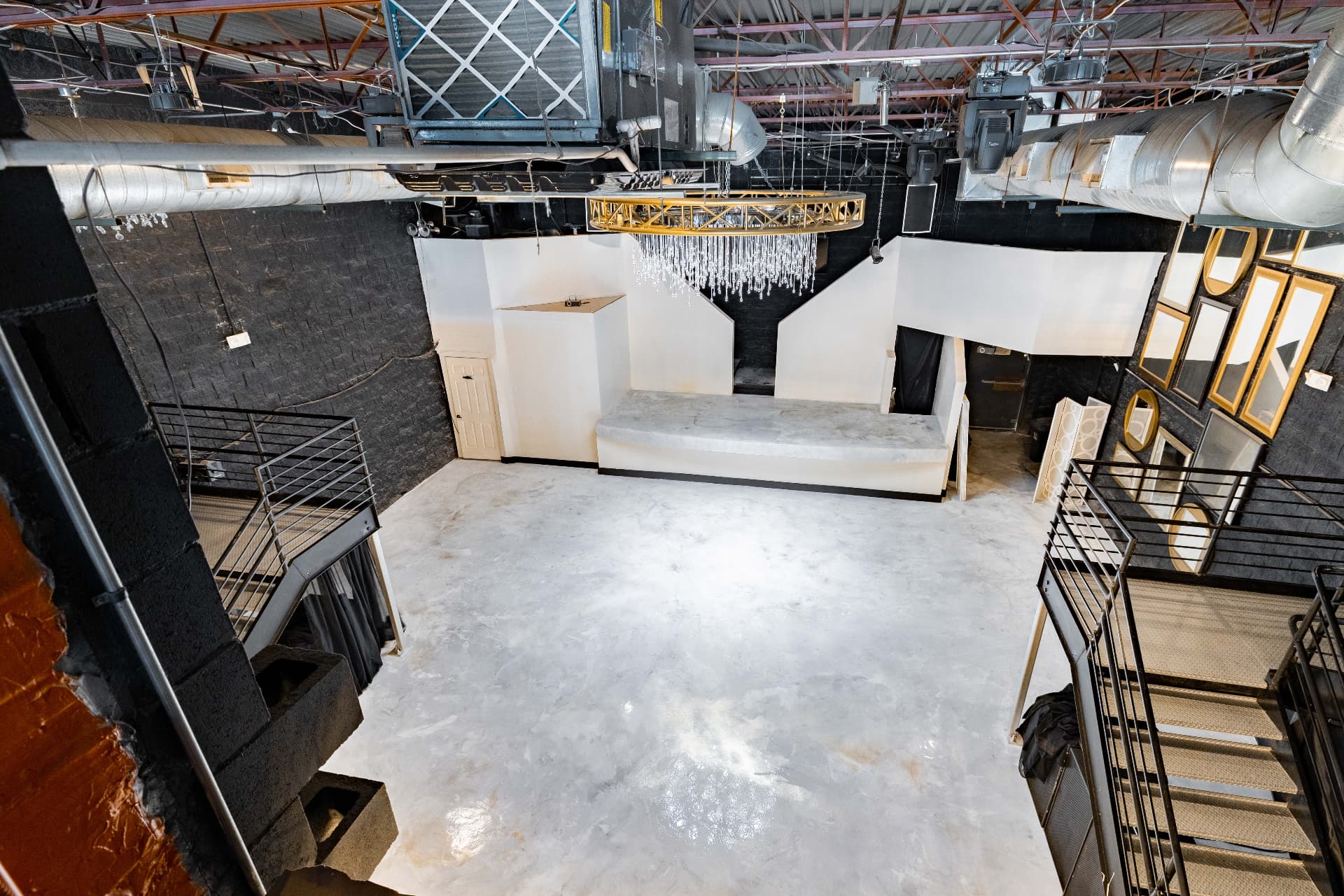 The empty two-story hall seen from the mezzanine railing