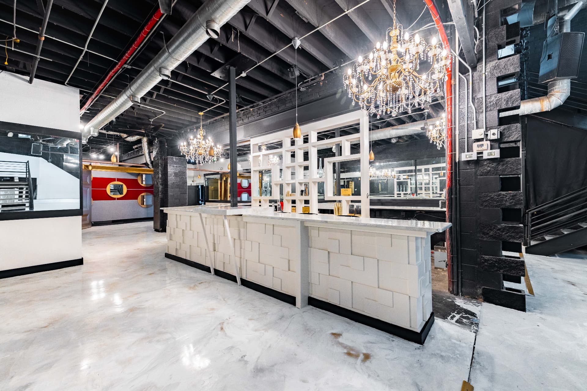 The bar area empty under crystal chandeliers